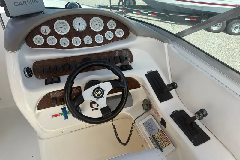 Slide: The Image of 2001 Sea Ray 280 Bow Rider dashboard with steering wheel and control panel. - 7