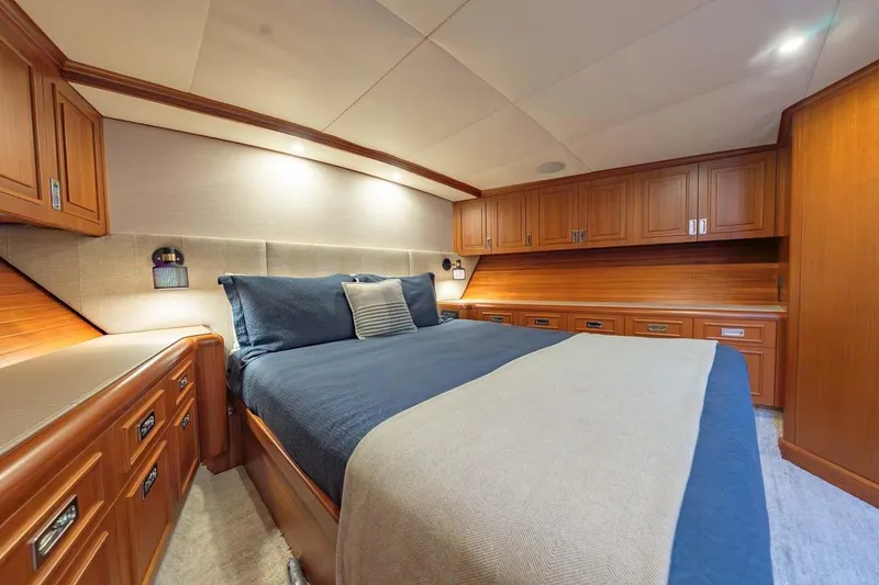 Slide: The Image of Luxurious bedroom interior of 1984 Feadship Yacht Fish with wooden cabinetry and cozy bedding. - 16