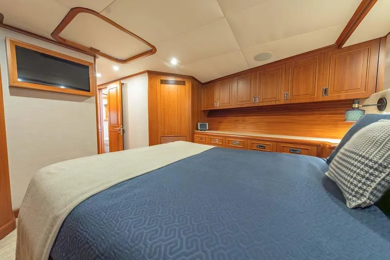 Slide: The Image of Luxurious cabin interior of 1984 Feadship Yacht Fish with wooden cabinetry and cozy bedding. - 17