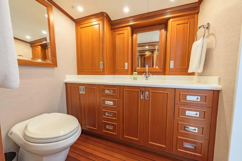 Slide: The Image of Luxurious wooden bathroom interior on 1984 Feadship Yacht Fish, featuring elegant cabinetry and fixtures. - 18