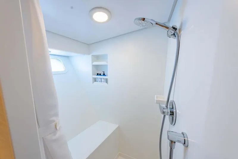 Slide: The Image of Modern shower area in 1984 Feadship Yacht Fish, featuring sleek fixtures and built-in shelving. - 20