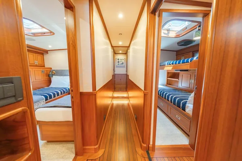 Slide: The Image of Luxurious 1984 Feadship Yacht Fish interior with wood paneling and cozy cabins. - 21