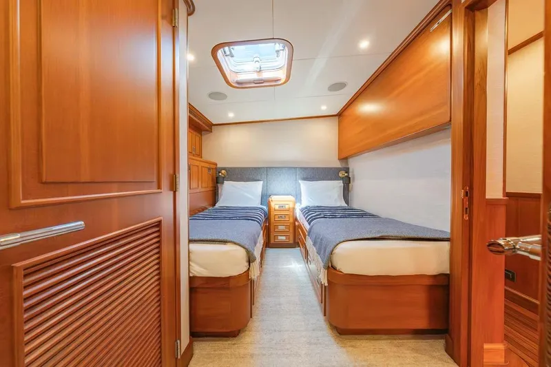 Slide: The Image of Luxurious twin cabin interior on 1984 Feadship Yacht Fish, featuring elegant wood finishes. - 22