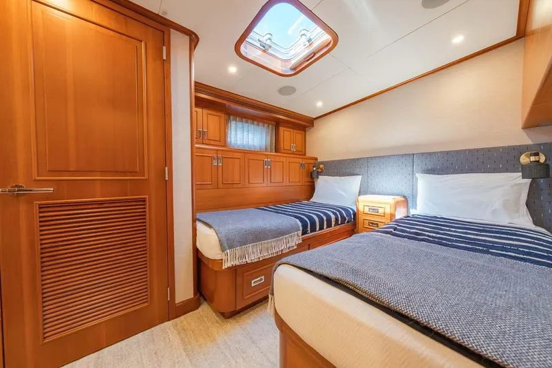 Slide: The Image of Luxurious 1984 Feadship Yacht Fish cabin with twin beds and elegant wood finishes. - 23