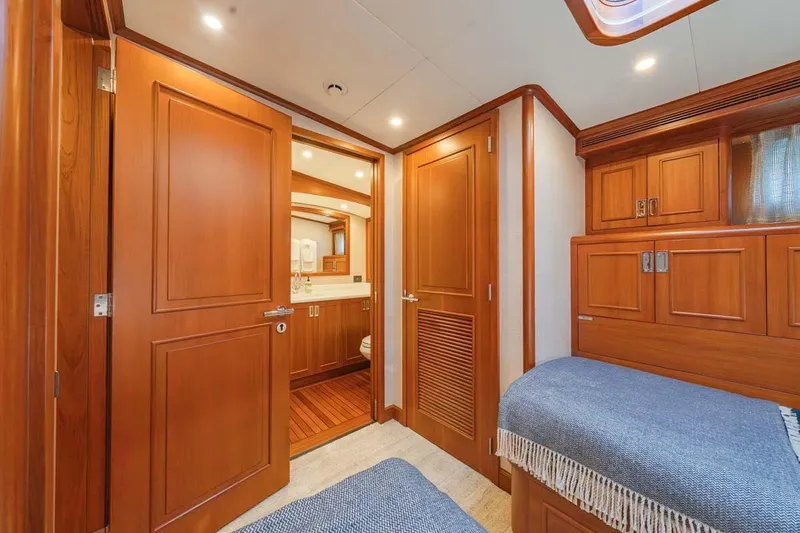 Slide: The Image of Luxurious 1984 Feadship Yacht Fish cabin with wooden interior and cozy bedding. - 25