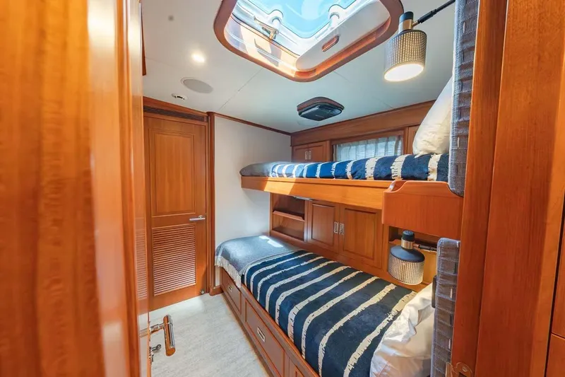Slide: The Image of Luxurious 1984 Feadship Yacht Fish cabin with wooden interior and bunk beds. - 27