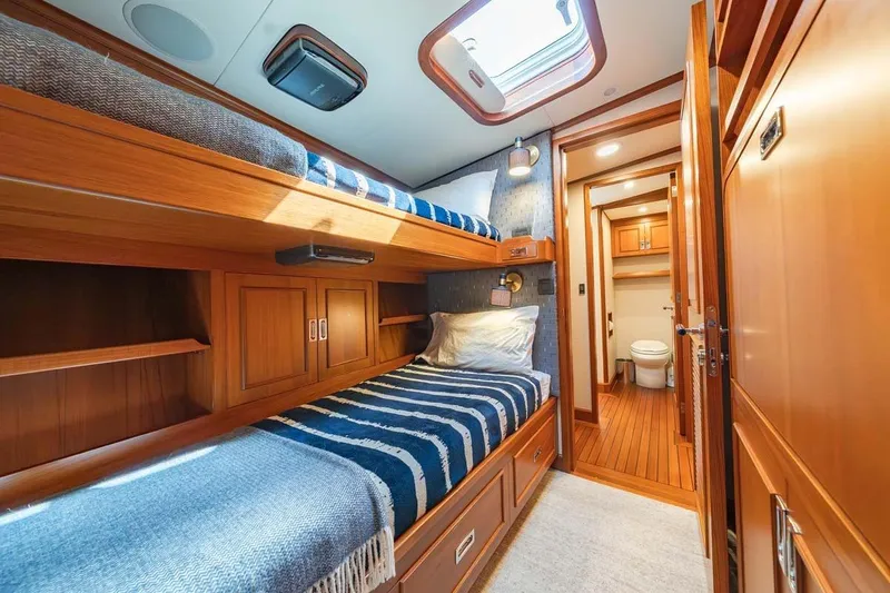 Slide: The Image of Luxurious 1984 Feadship Yacht Fish cabin with wooden interior and bunk beds. - 28