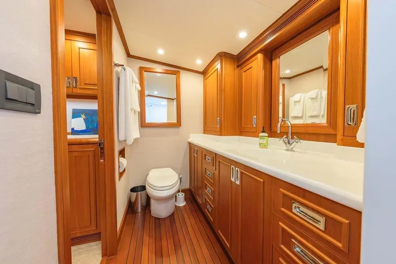 Slide: The Image of Luxurious 1984 Feadship Yacht Fish bathroom with wooden cabinetry and modern fixtures. - 29