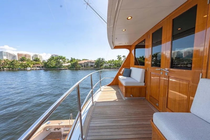 Slide: The Image of Luxurious 1984 Feadship Yacht Fish deck with wooden finish and waterfront view. - 39
