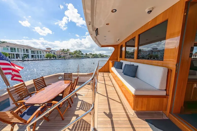 Slide: The Image of Luxurious 1984 Feadship Yacht Fish deck with seating, dining area, and waterfront view. - 4