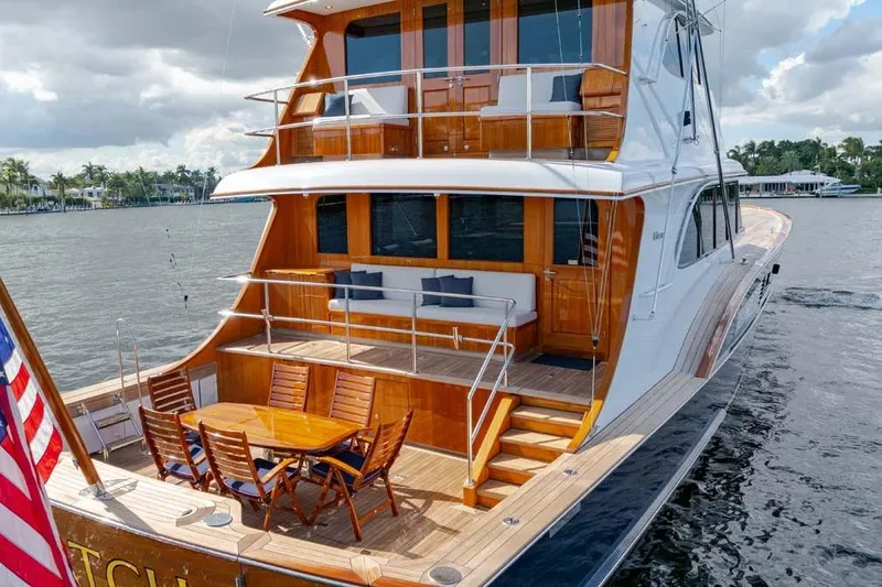 Slide: The Image of Luxurious 1984 Feadship Yacht Fish with elegant wooden deck and outdoor seating. - 41