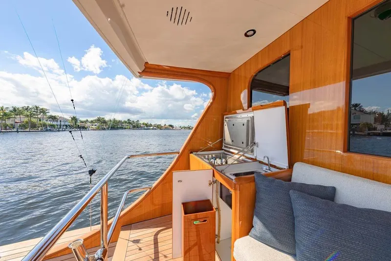 Slide: The Image of Luxurious 1984 Feadship Yacht Fish with outdoor seating and water view. - 5