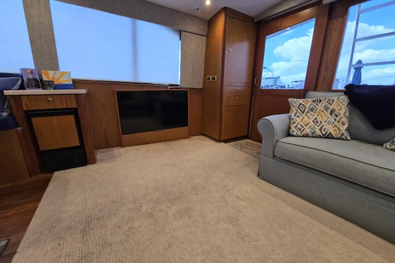Slide: The Image of Luxurious interior of 1982 Ocean Yachts 55 Super Sport, featuring cozy seating and modern amenities. - 13