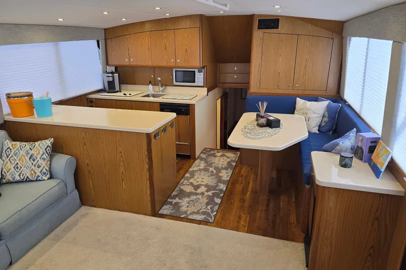 Slide: The Image of Interior of 1982 Ocean Yachts 55 Super Sport, featuring modern kitchen and cozy seating area. - 14