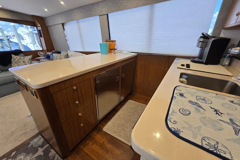 Slide: The Image of Luxurious kitchen interior of Ocean Yachts 55 Super Sport, featuring modern appliances and elegant design. - 16
