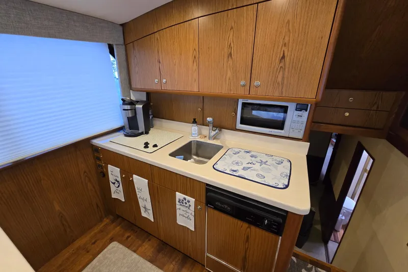 Slide: The Image of Galley kitchen in 1982 Ocean Yachts 55 Super Sport, featuring wood cabinets and modern appliances. - 17