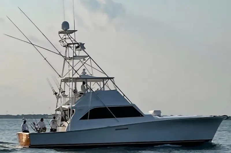Slide: The Image of Ocean Yachts 55 Super Sport 1982 model cruising on calm waters at sunset. - 2