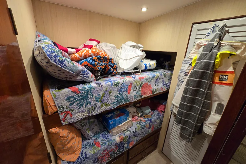 Slide: The Image of Bunk beds with colorful bedding in Ocean Yachts 55 Super Sport, 1982 model interior. - 27