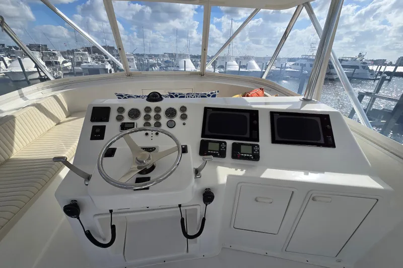 Slide: The Image of Cockpit of Ocean Yachts 55 Super Sport 1982, featuring steering wheel and navigation instruments. - 28