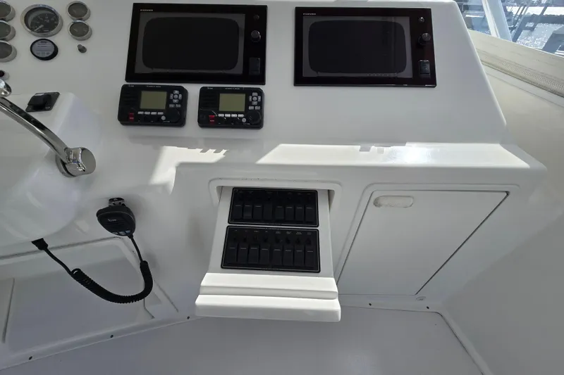 Slide: The Image of Control panel of Ocean Yachts 55 Super Sport 1982, featuring modern navigation equipment. - 30