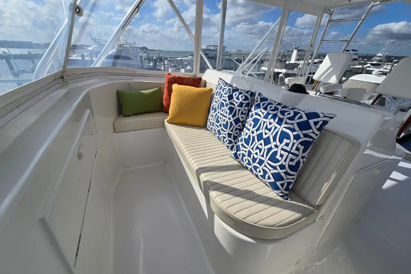 Slide: The Image of Luxurious seating area on Ocean Yachts 55 Super Sport, featuring colorful cushions and marina view. - 33