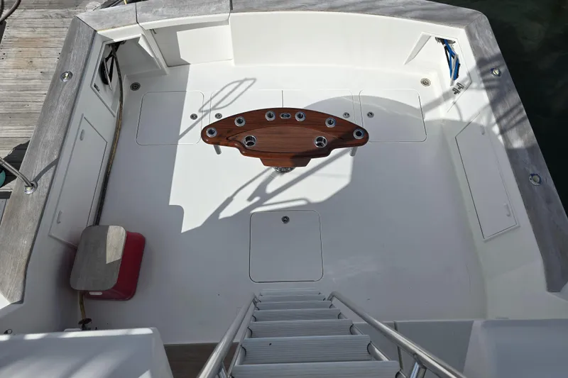 Slide: The Image of Cockpit of Ocean Yachts 55 Super Sport 1982, featuring a central wooden table. - 34