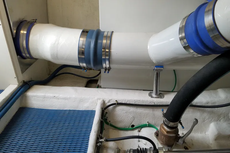 Slide: The Image of Engine room piping of Ocean Yachts 55 Super Sport, 1982 model, featuring blue and white components. - 40