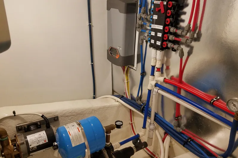 Slide: The Image of Engine room of Ocean Yachts 55 Super Sport 1982, featuring plumbing and electrical systems. - 41