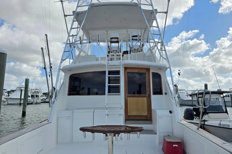 Slide: The Image of Ocean Yachts 55 Super Sport 1982 model, docked with ladder and fishing setup. - 5