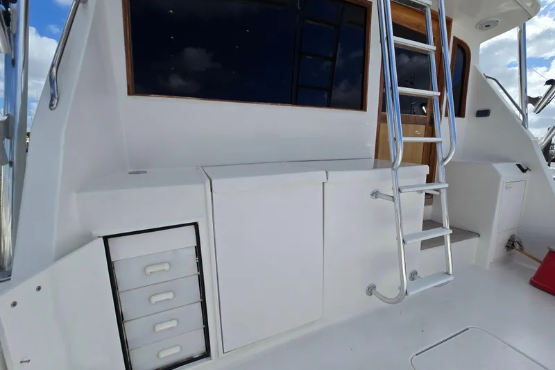 Slide: The Image of Ocean Yachts 55 Super Sport 1982, exterior view with ladder and storage compartments. - 9