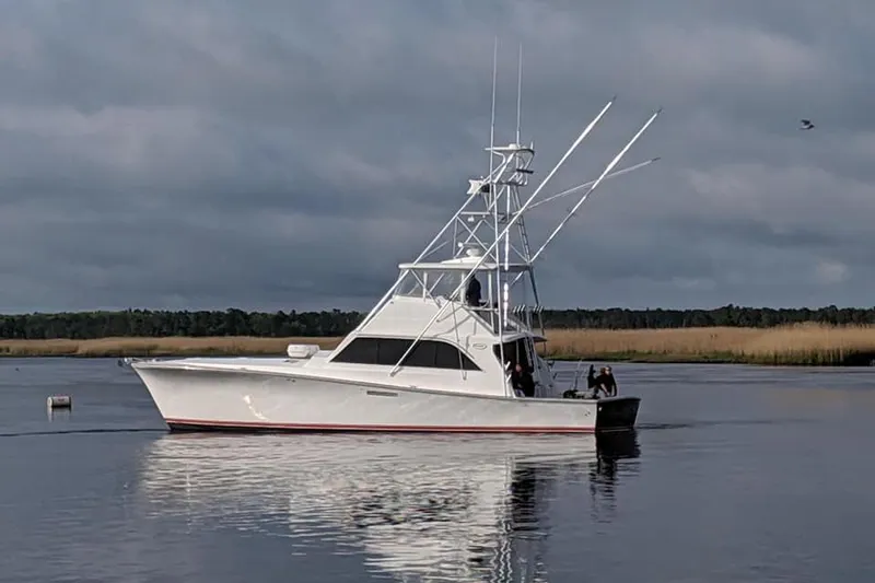 The Image of Ocean Yachts 55 Super Sport 1982 model on calm water under cloudy sky. - 0