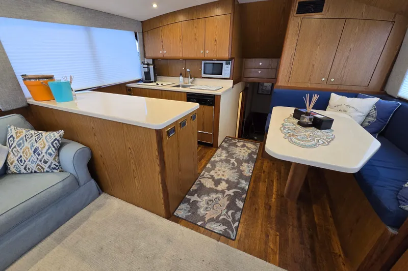 Slide: The Image of Interior of 1982 Ocean Yachts 55 Super Sport, featuring kitchen and dining area. - 10