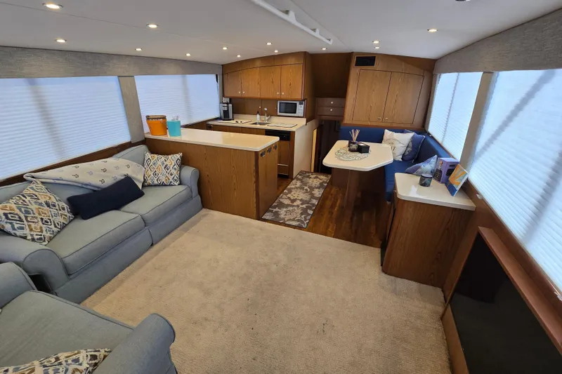 Slide: The Image of Luxurious interior of 1982 Ocean Yachts 55 Super Sport, featuring cozy seating and modern kitchen. - 15