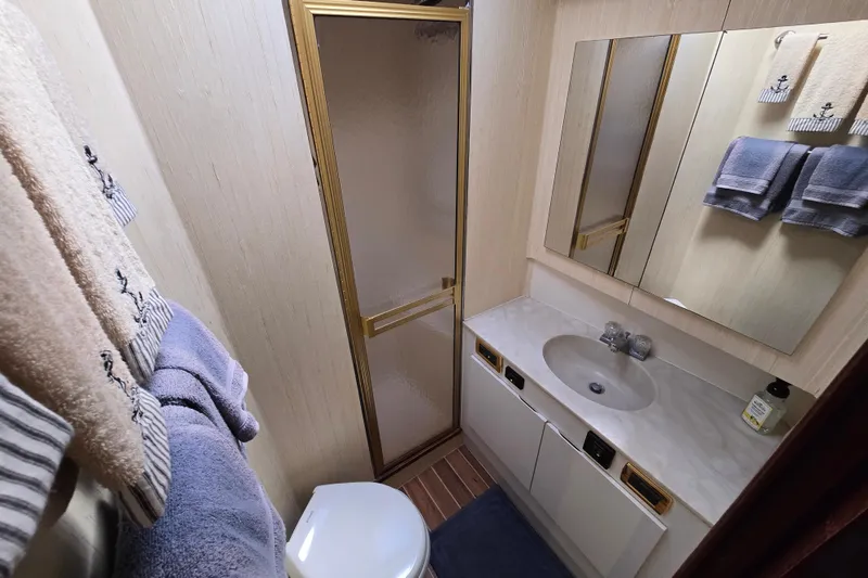 Slide: The Image of Bathroom interior of 1982 Ocean Yachts 55 Super Sport, featuring shower and sink. - 26