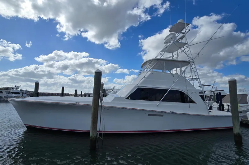 Slide: The Image of Ocean Yachts 55 Super Sport 1982 model docked under a partly cloudy sky. - 3