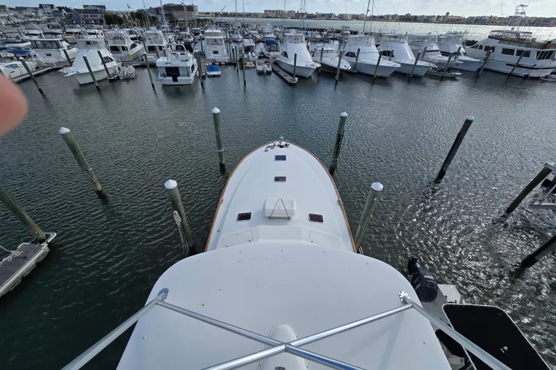 Slide: The Image of Ocean Yachts 55 Super Sport 1982 docked in a marina, surrounded by other boats. - 35
