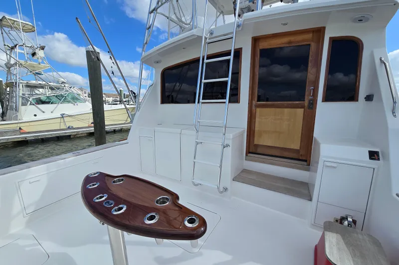 Slide: The Image of Ocean Yachts 55 Super Sport 1982, featuring a sleek deck and ladder under a blue sky. - 7