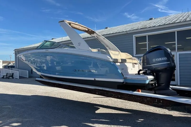 Slide: The Image of 2021 Regal 23 OBX boat with Yamaha outboard motor, displayed outdoors. - 10