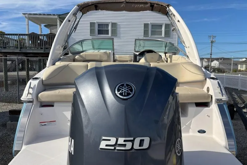 Slide: The Image of 2021 Regal 23 OBX boat with Yamaha 250 outboard motor, beige seating, and white exterior. - 11
