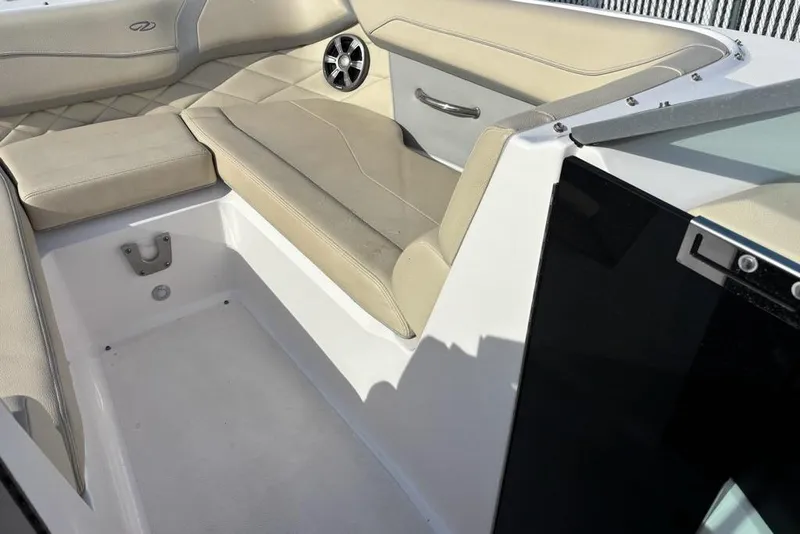 Slide: The Image of 2021 Regal 23 OBX boat interior with beige seating and speaker detail. - 16