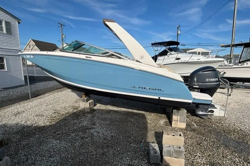 Slide: The Image of 2021 Regal 23 OBX boat with Yamaha outboard engine on display outdoors. - 24