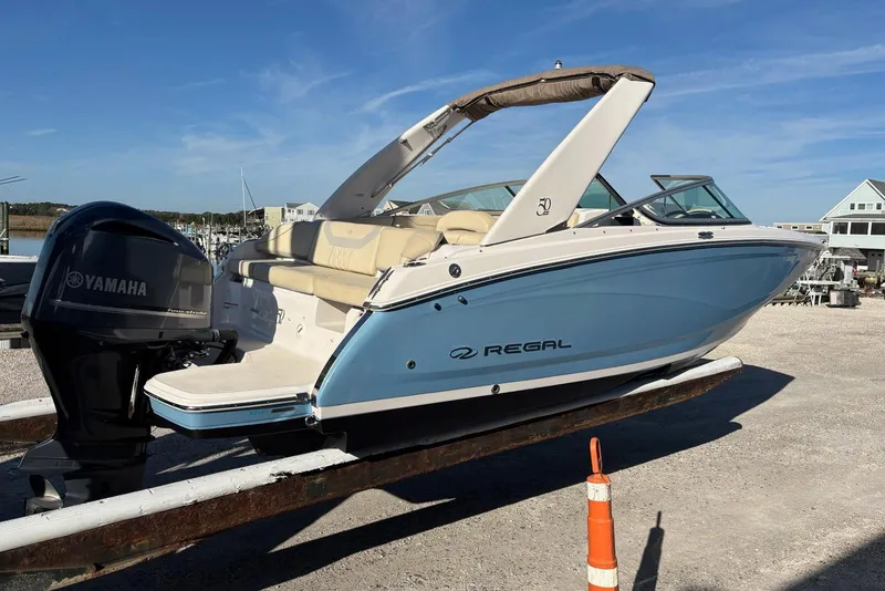 Slide: The Image of 2021 Regal 23 OBX boat with Yamaha outboard motor on a trailer. - 5