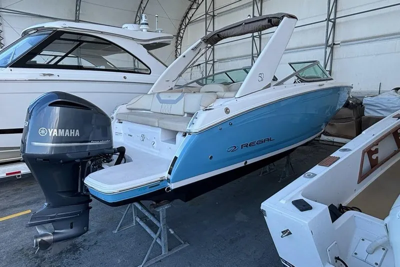 Slide: The Image of 2021 Regal 23 OBX boat with Yamaha outboard motor in storage facility. - 8