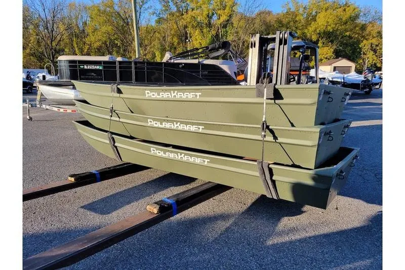 The Image of 2024 Polar Kraft 1436 Jon Boats stacked, green, 14-foot length, outdoor display. - 1