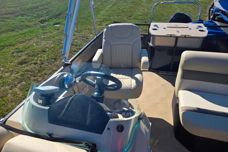 Slide: The Image of 2016 Crest II Fish 210 C4 boat interior with steering wheel and seating. - 13