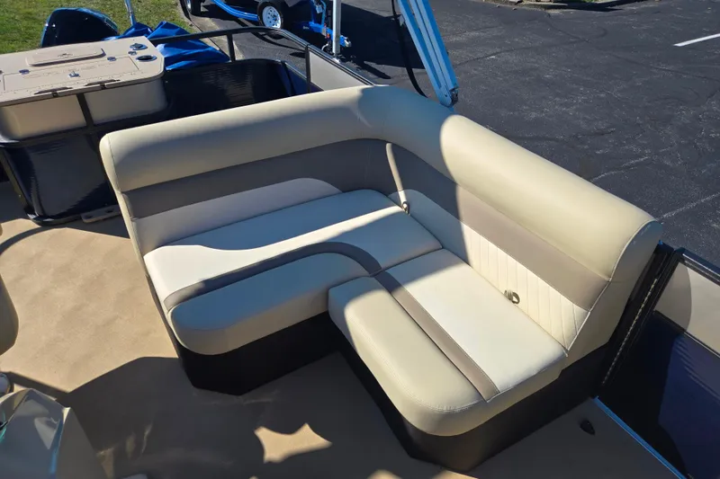Slide: The Image of 2016 Crest II Fish 210 C4 boat interior with beige seating and storage area. - 14
