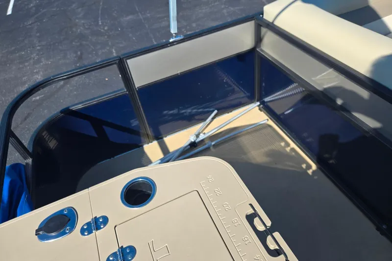 Slide: The Image of 2016 Crest II Fish 210 C4 boat interior with fishing rod holders and seating area. - 19