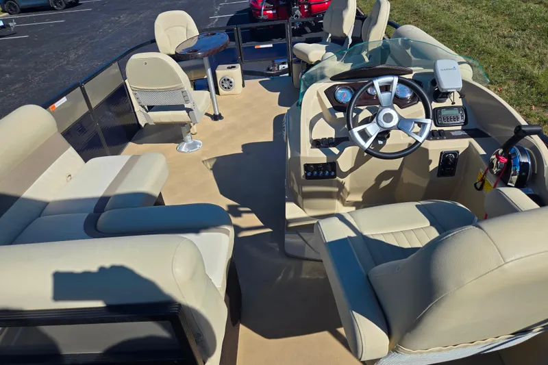 Slide: The Image of 2016 Crest II Fish 210 C4 pontoon boat interior with beige seating and steering console. - 20