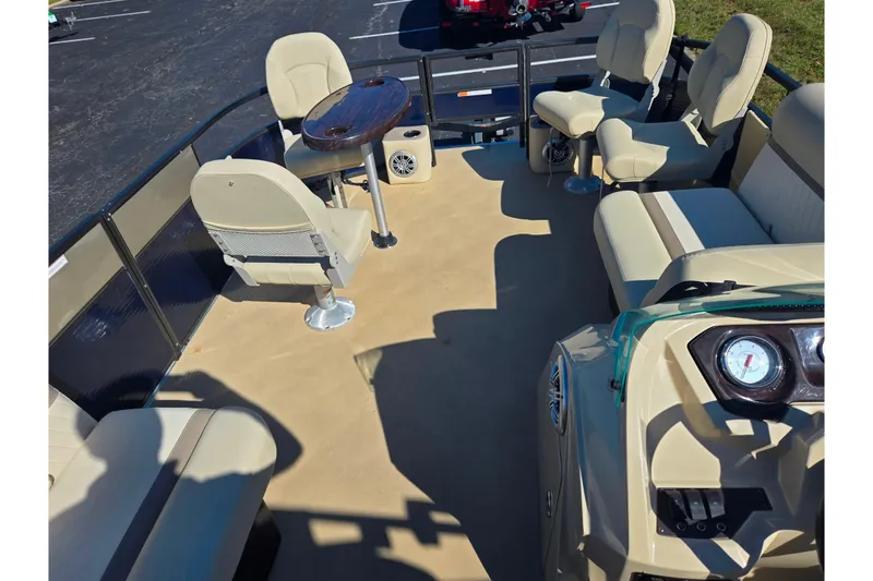 Slide: The Image of 2016 Crest II Fish 210 C4 boat interior with beige seating and a small table. - 21