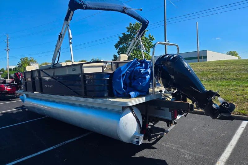 Slide: The Image of 2016 Crest II Fish 210 C4 pontoon boat with outboard motor in parking lot. - 3